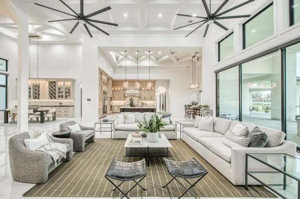 a view of a dining room with furniture large windows and wooden floor