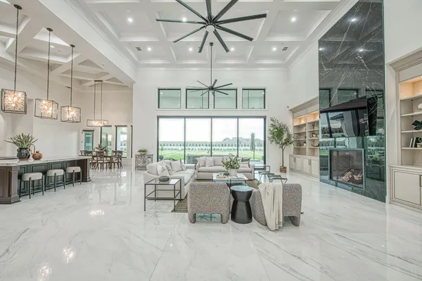 a view of a livingroom with furniture and a bookshelf