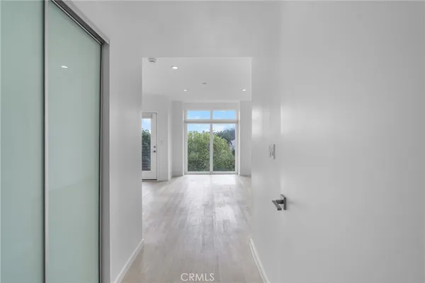 an empty room with windows and entrance