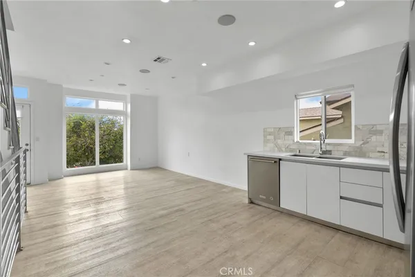 a kitchen with stainless steel appliances a refrigerator sink and microwave