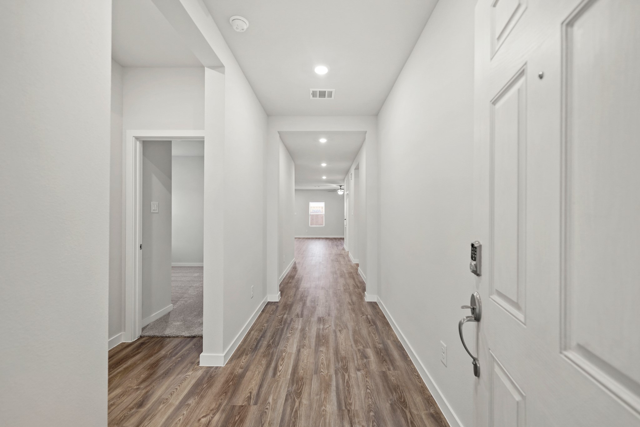 14405 Elmfield Lane Conroe, TX 77303 - Photo 2 of 22 a view of a hallway with wooden floor