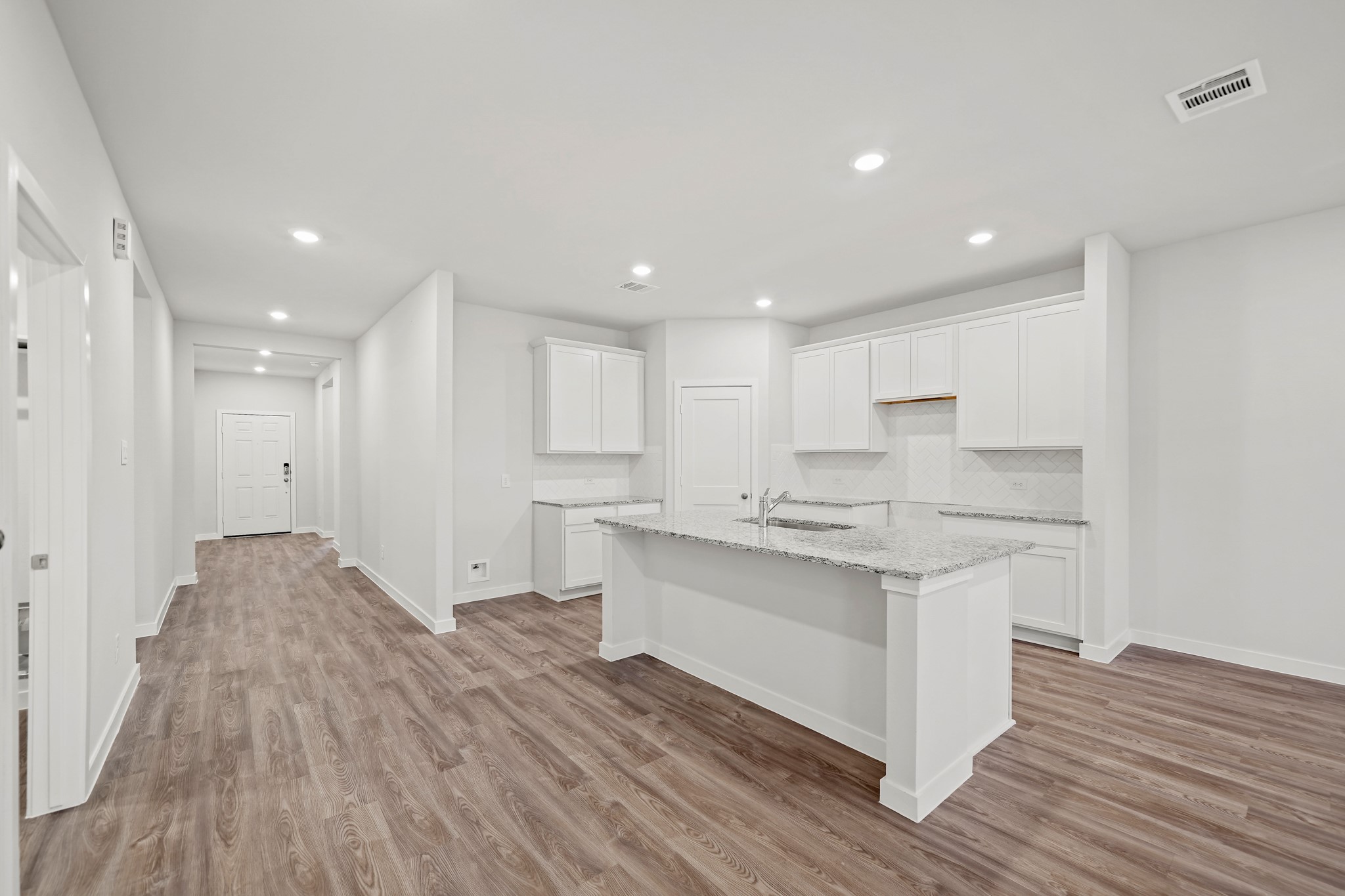 14405 Elmfield Lane Conroe, TX 77303 - Photo 3 of 22 a kitchen with stainless steel appliances granite countertop a white cabinets and wooden floors