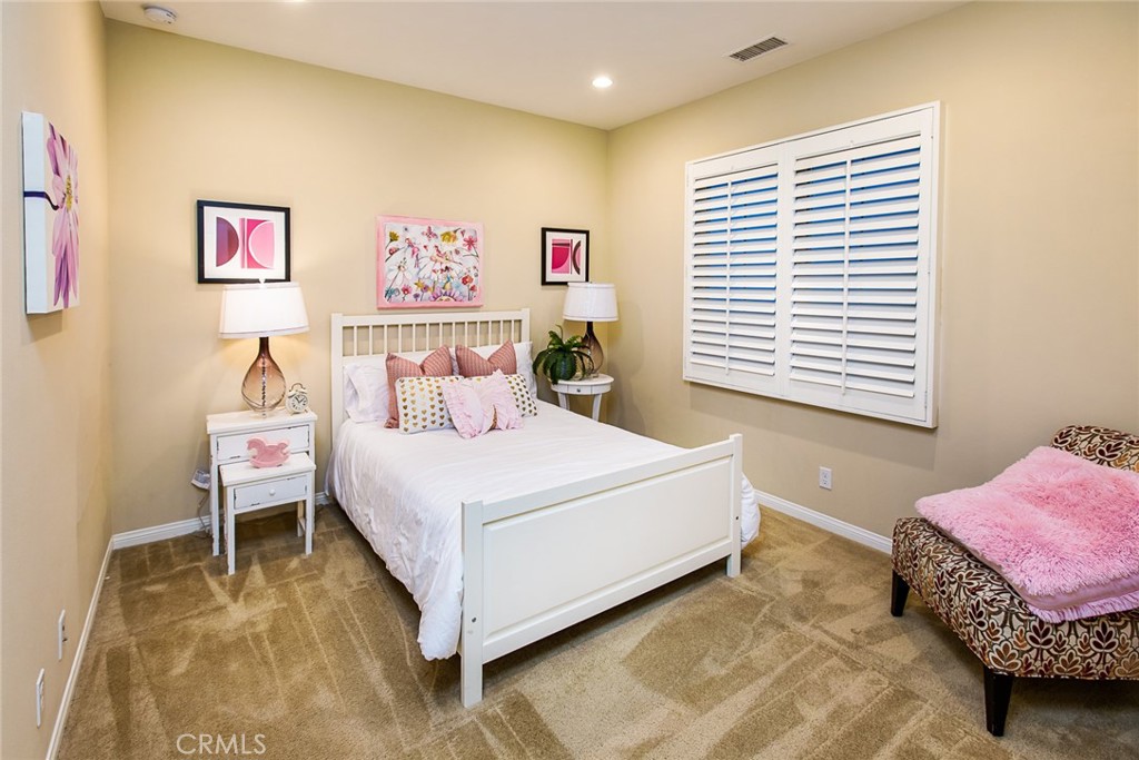 75 Gardenstone Path Irvine, CA 92620 - Photo 23 of 65 a bedroom with a bed and a table