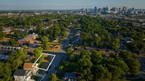 an aerial view of residential house with outdoor space and trees all around