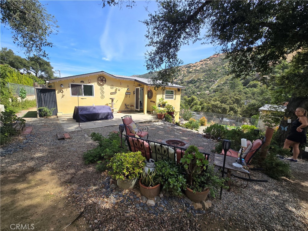 1070 Alta Vista Road Simi Valley, CA 93063 - Photo 1 of 1 a view of a patio with table and chairs potted plants and large tree