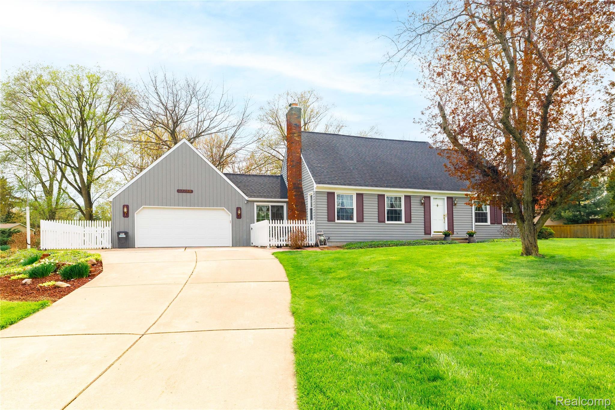 27758 Johnson Road Grosse Ile, MI 48138 - Photo 3 of 49 Cape cod home featuring driveway, a garage, a chimney, and a shingled roof
