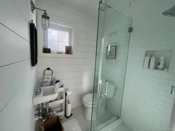 a bathroom with a toilet sink and shower