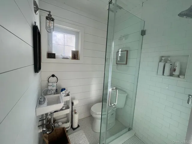 a bathroom with a toilet sink and shower