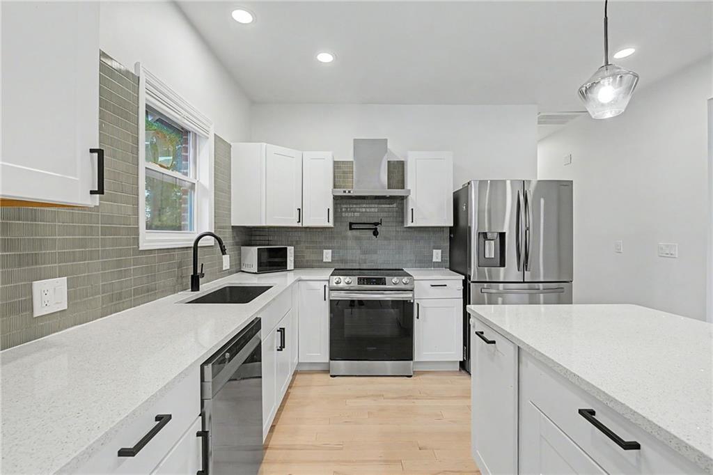 827 Elbert Street Southwest Atlanta, GA 30310 - Photo 5 of 33 a kitchen with a sink stove and refrigerator