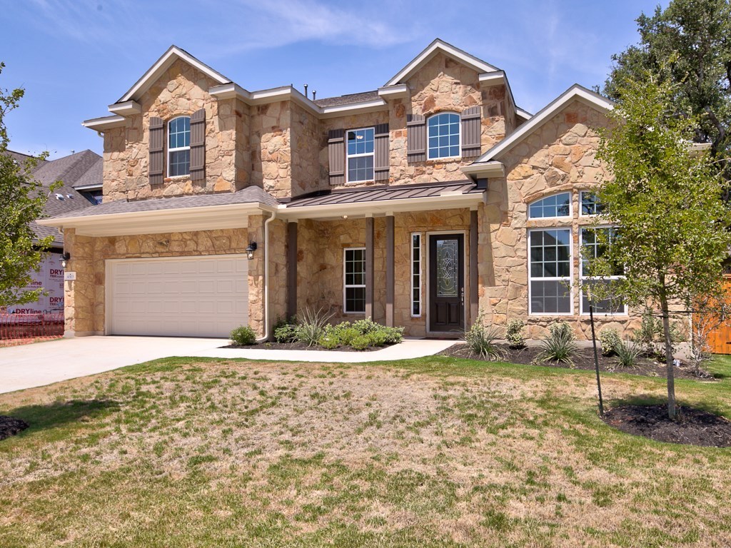 4303 Logan Ridge Drive Cedar Park, TX 78613 - Photo 1 of 24 Stone facade with multiple gables, arched windows, decorative shutters, a covered entry, and an integrated two-car garage