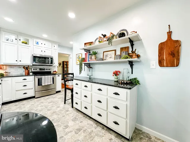a kitchen with stainless steel appliances granite countertop a sink and cabinets