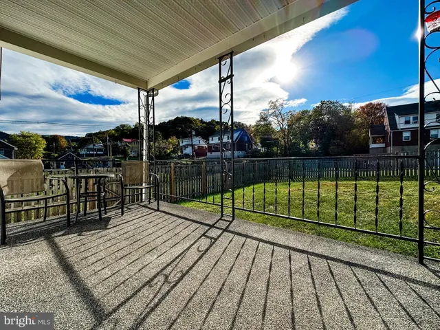 a swimming pool with yard in front of it