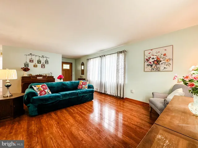 a living room with furniture window and wall painting