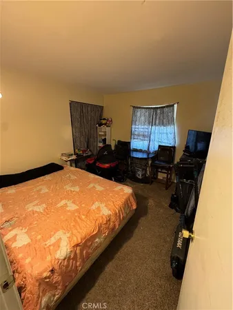 a bed room with furniture and a lamp