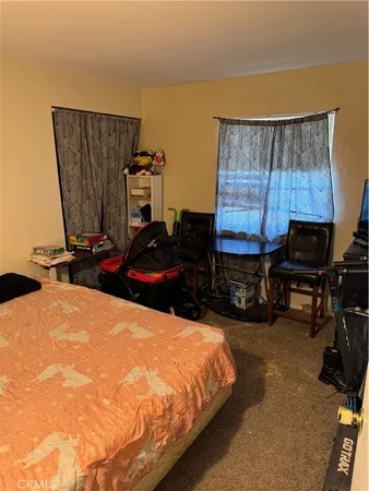 a bedroom with bed and a window