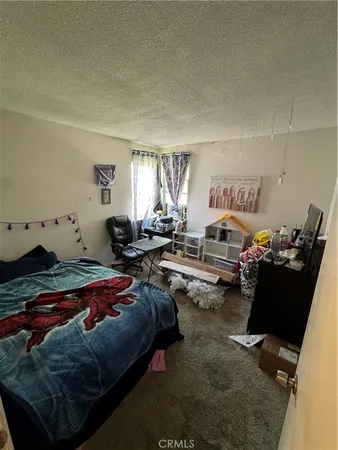 a bedroom with bed and a window