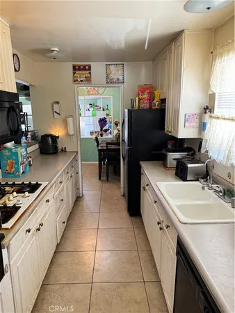 a kitchen with stainless steel appliances a stove a sink and a refrigerator