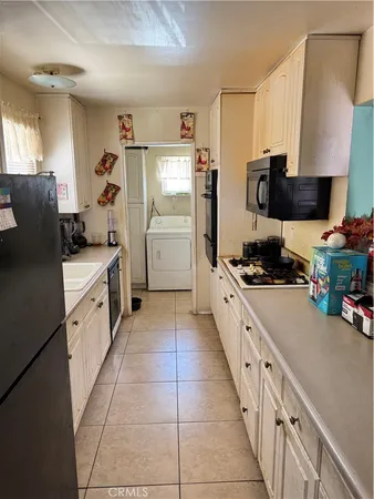 a view of a hallway with dining area and chandelier