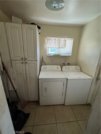 a view of a patio with a table and chairs under an umbrella