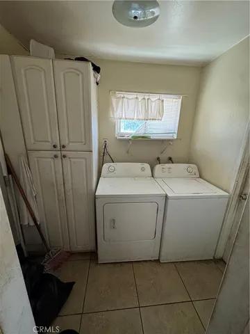 a view of a patio with a table and chairs under an umbrella