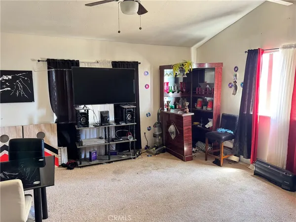 a bedroom with a bed and a television