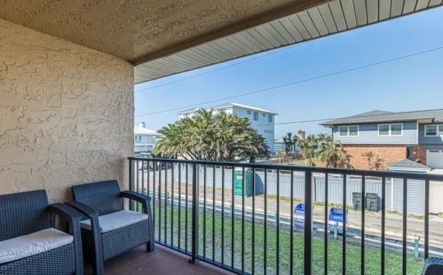 a view of a balcony with furniture