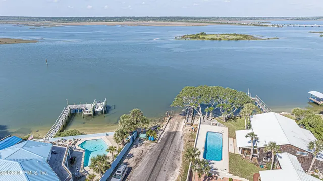 a living room with furniture a flat screen tv and a floor to ceiling window