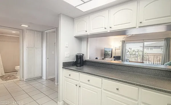 a kitchen with granite countertop white cabinets stainless steel appliances and a sink