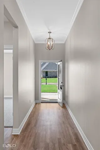 a view of empty room with wooden floor fan and window