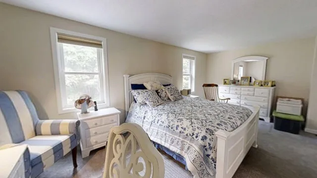 a living room with a bed furniture and a window
