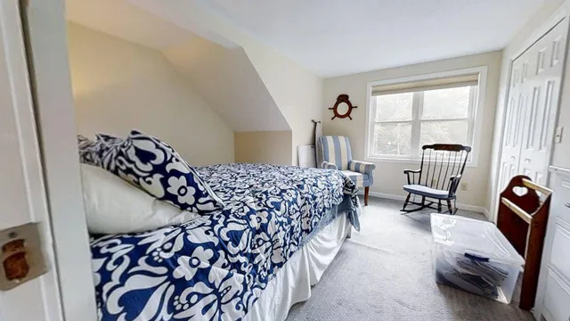 a bedroom with furniture and a window