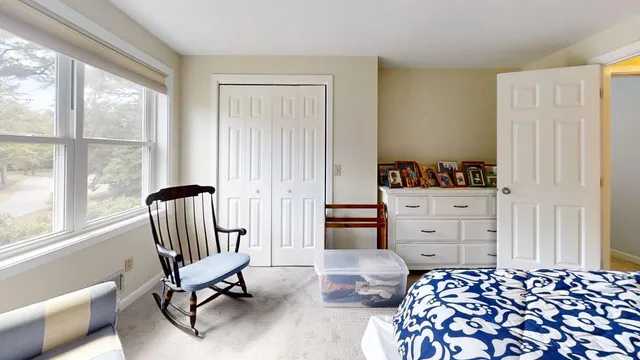 a bedroom with furniture and a window