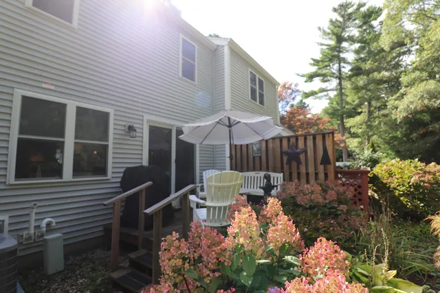 a view of a chair and table in backyard