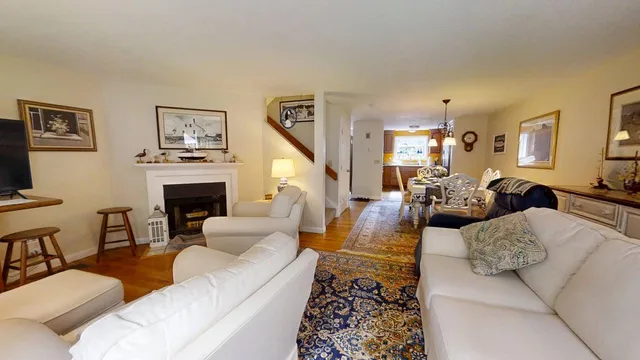 a living room with furniture a rug and a fireplace