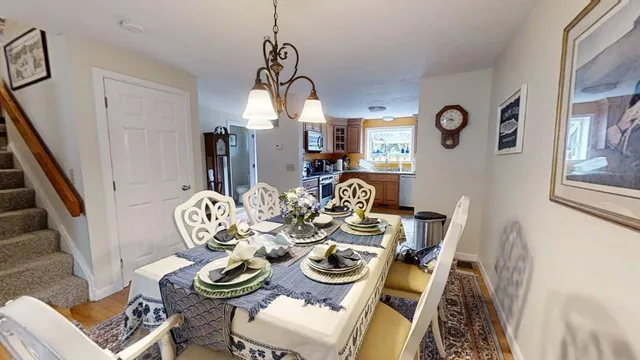a view of a dining room with furniture chandelier and wooden floor