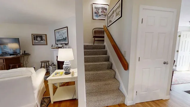 a view of entryway and hall with wooden floor