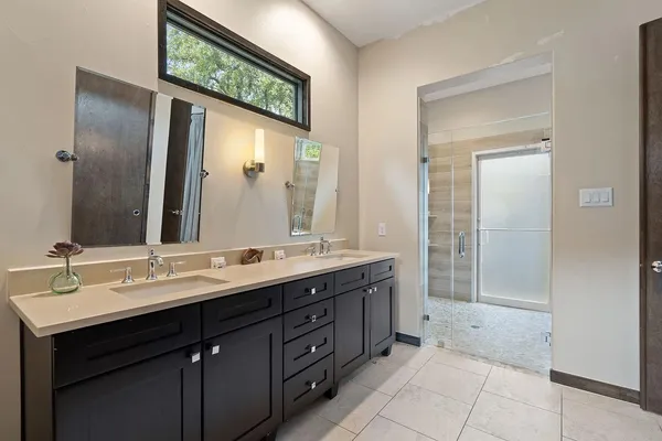 a bathroom with a double vanity sink and a mirror