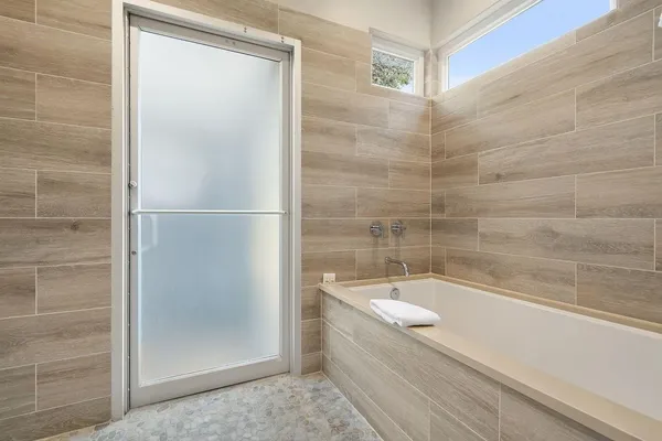 a bathroom with a bathtub and shower