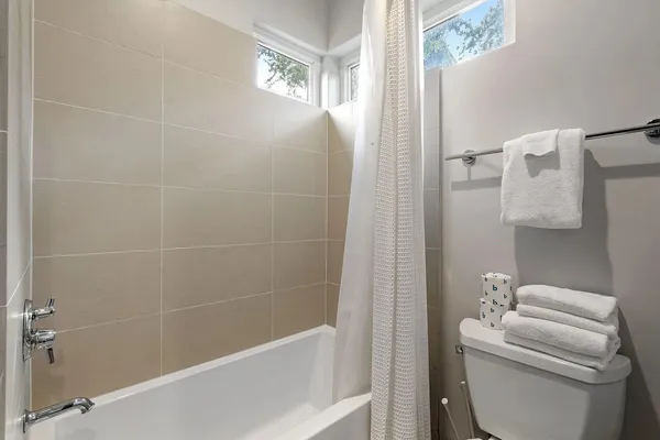 a bath room with a toilet and a bath tub