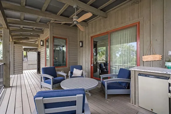 a outdoor space with patio the couches and a dining table with wooden floor