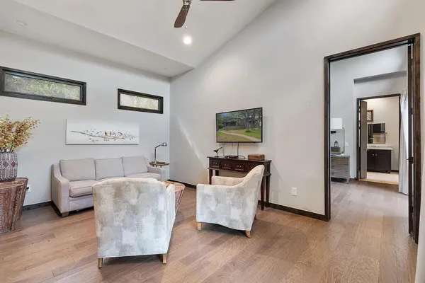 a living room with furniture and a wooden floor