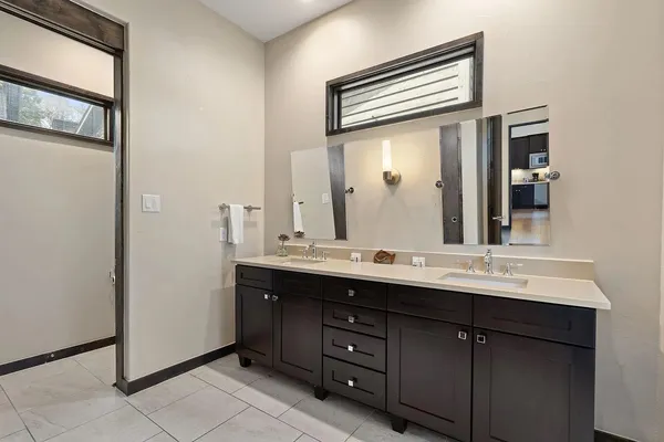 a bathroom with a double vanity sink and a mirror