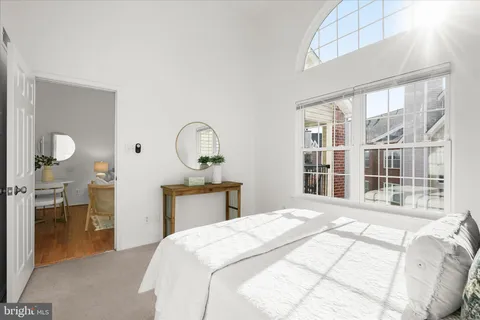 a bedroom with a large bed and a window