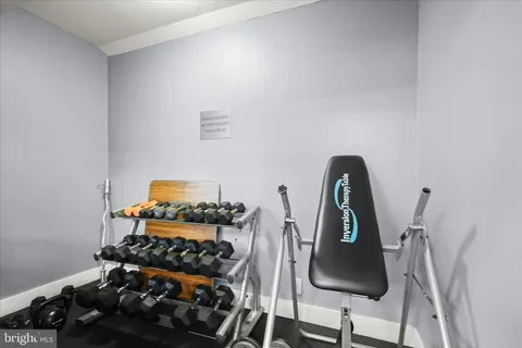 a room with wooden floor and shelf