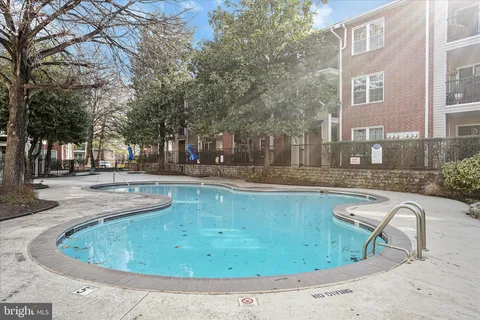 a view of swimming pool with outdoor seating and plants