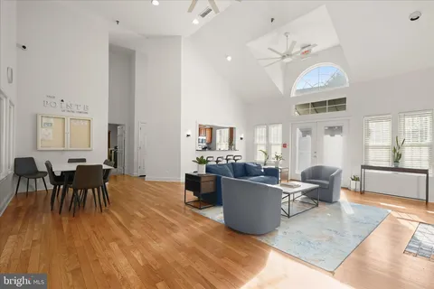 a living room with furniture a fireplace and potted plants