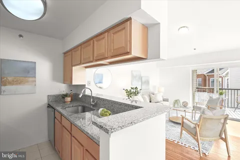 a kitchen with granite countertop a sink a stove and cabinets