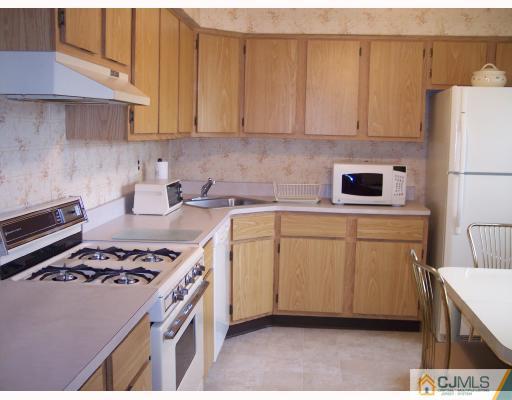 8006 Hana Road Edison, NJ 08817 - Photo 2 of 9 a kitchen with a sink a stove and cabinets