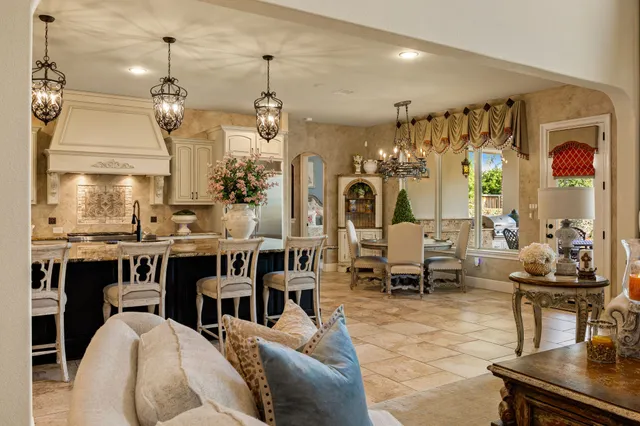 a living room with lots of furniture and kitchen view