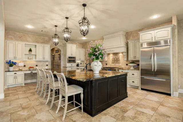 a kitchen with stainless steel appliances kitchen island granite countertop a sink and cabinets